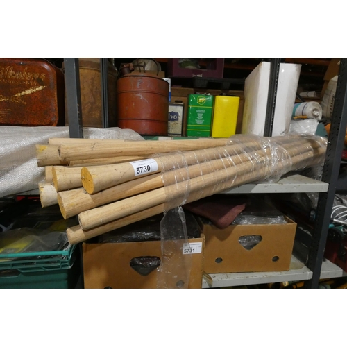 5730 - A quantity of various wooden handles for axes, pick axes etc. Contents of 1 shelf