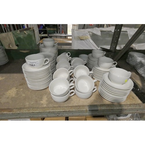 1061 - A quantity of cream cups and saucers by Olympia