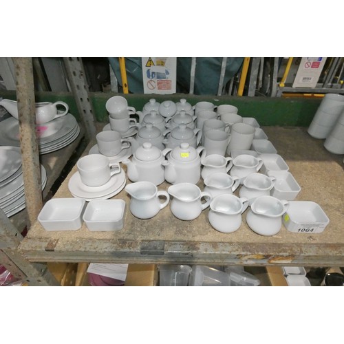 1064 - A quantity of various white crockery including tea pots, milk jugs, mugs etc