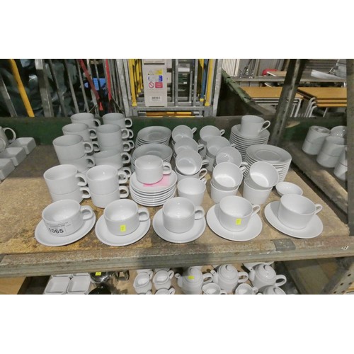 1065 - A quantity of white cups and saucers by Athena and Schonwald