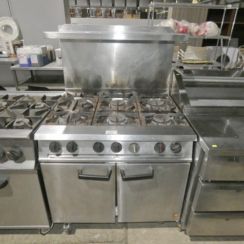 1211 - A gas fired 6 burner range with 2 door oven beneath and shelf above, by Falcon - trade