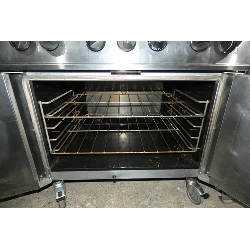 1218 - A commercial stainless steel gas fired 6 ring range with 2 door oven beneath by Falcon, Dominator - ... 