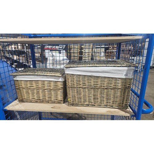 282 - 2 x graduating size fabric lined baskets - largest is approx 57 x 40 x 39cm high