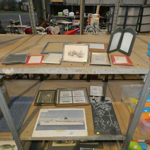 2121 - A quantity of various prints, frames and a slate chalk board. Contents of 2 shelves