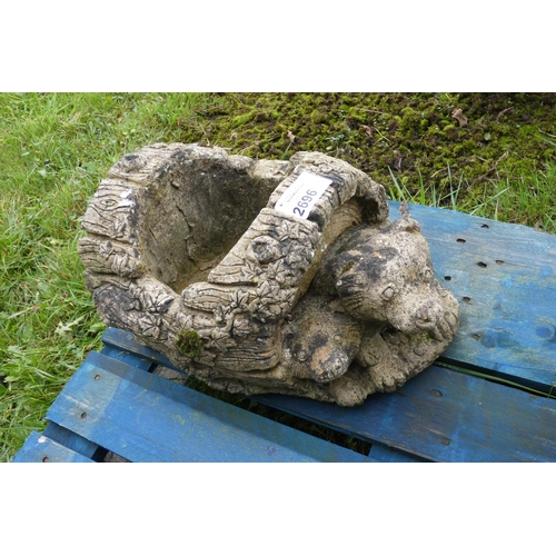 2696 - A decorative concrete planter with badgers