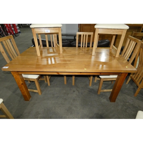 2746 - A wooden dining table approx 180x92cm, requires small repair.