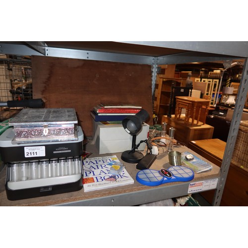 2111 - A quantity of various household items including a coin sorter, a table lamp 240v, books, DVDs etc. C... 