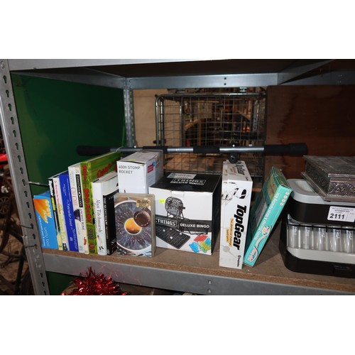 2111 - A quantity of various household items including a coin sorter, a table lamp 240v, books, DVDs etc. C... 