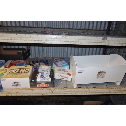 2181 - A quantity of various games and a small painted wooden dolls cot / cradle. Contents of 1 shelf