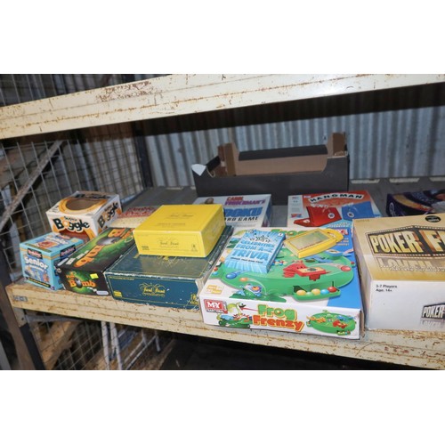 2181 - A quantity of various games and a small painted wooden dolls cot / cradle. Contents of 1 shelf