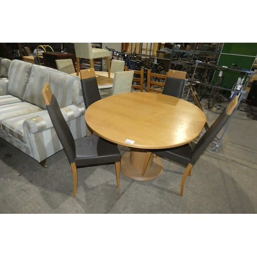 2064 - An oval centre pedestal extending wooden dining table by J E Coyle approx 134 x 118cm fitted with a ... 