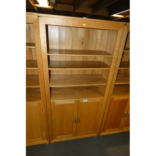 2160 - A light Oak cabinet with 3 shelves above and 2 doors below approx 90 x 38 x 196cm high