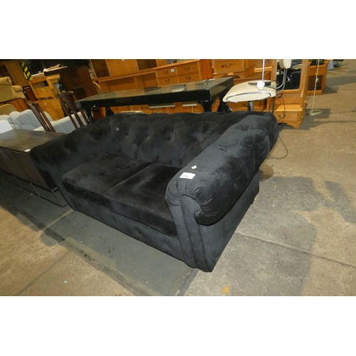 2143 - A black upholstered button back sofa approx 180cm wide