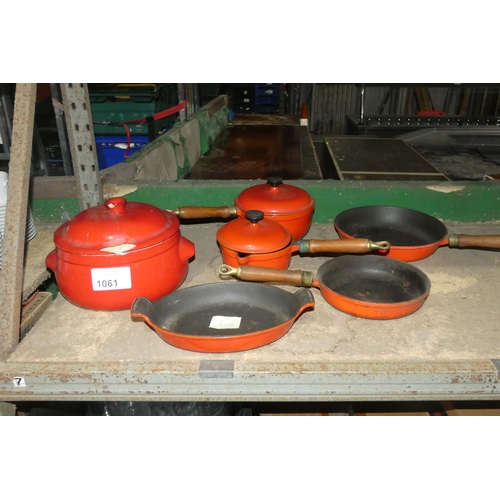 1061 - A set of Salter cast iron cooking pots and pans in red and a ceramic stock pot with a repaired lid