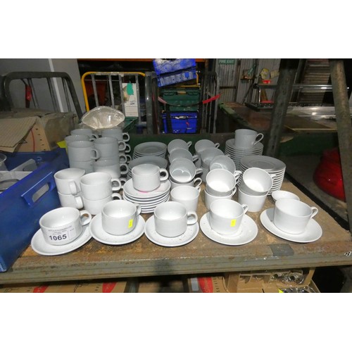 1065 - A quantity of white cups and saucers by Athena and Schonwald