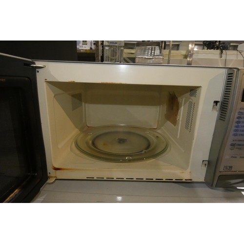 1147 - A microwave oven by Sharp type R-345 - trade