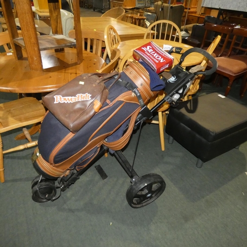 2229 - A Pace wheeled golf caddy with a bag containing various golfing items including 4 x various clubs an... 