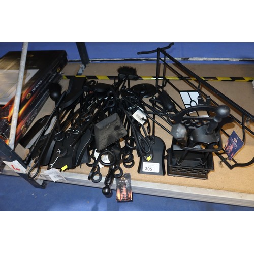 305 - A quantity of various black metal fireside companion tools. Not practical to list in detail so pleas... 