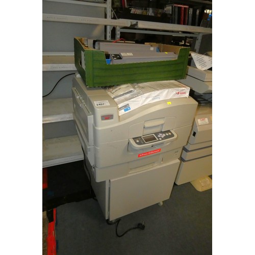 2407 - An office printer by Oki type N31204B, comes with a cabinet and spare, part used cartridges - trade