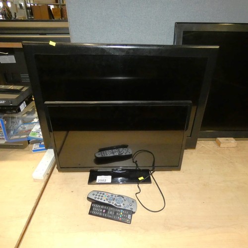 2502 - A 32 inch flatscreen TV by Bush and a 24 inch LED TV by JVC, remotes and stands included - smaller T... 