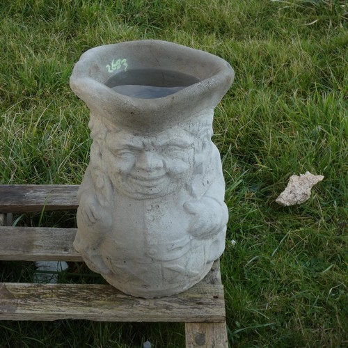 2623 - A concrete Toby jug planter/umbrella stand