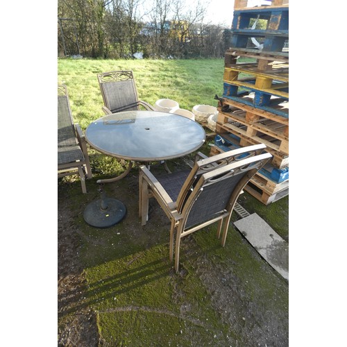 2631 - A large aluminium garden set comprising of a round glass table and 4 matching chairs