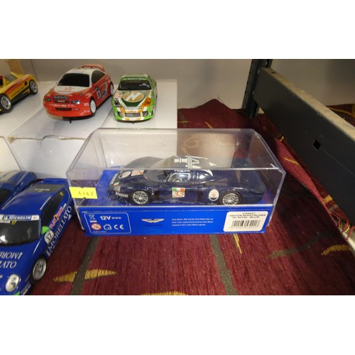 A Scalextric racing set with cars, track and controllers (two shelves)