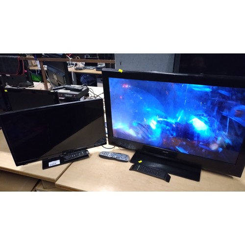 2502 - A 32 inch flatscreen TV by Bush and a 24 inch LED TV by JVC, remotes and stands included - smaller T... 