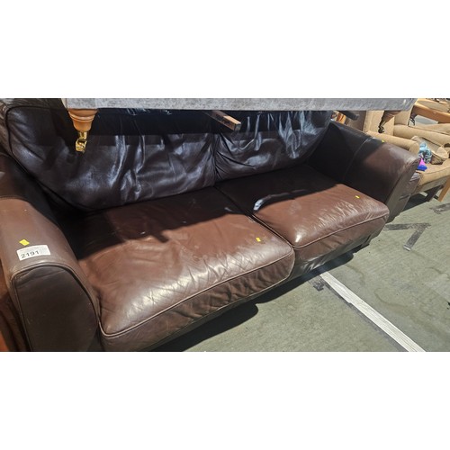 2191 - A brown upholstered sofa approx 210cm wide (probably part leather upholstered) and 1 x matching foot... 