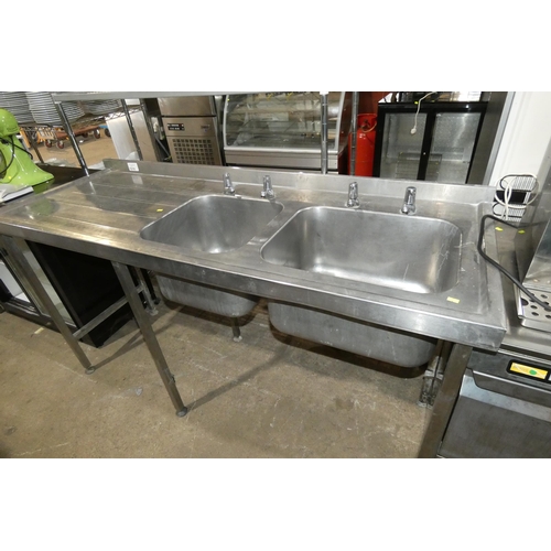 1210 - A commercial stainless steel twin sink unit with draining board to the left approx 180x66cm