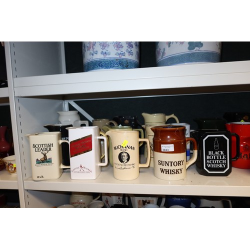 3043 - A quantity of miscellaneous decorative advertising whisky water jugs and other decorative glassware ... 