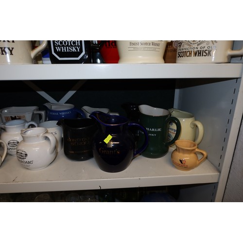 3043 - A quantity of miscellaneous decorative advertising whisky water jugs and other decorative glassware ... 