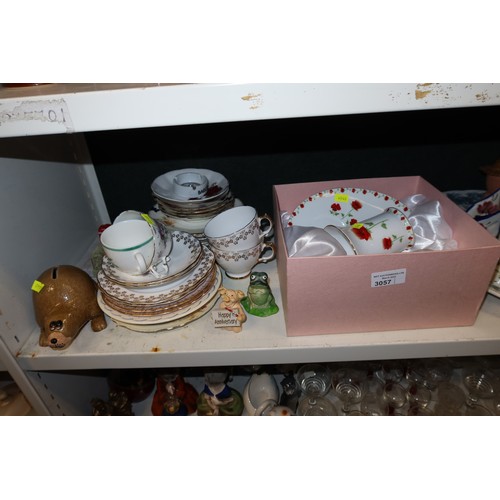 3057 - A quantity of miscellaneous decorative tea ware, glassware, ornaments and trinkets etc (three shelve... 