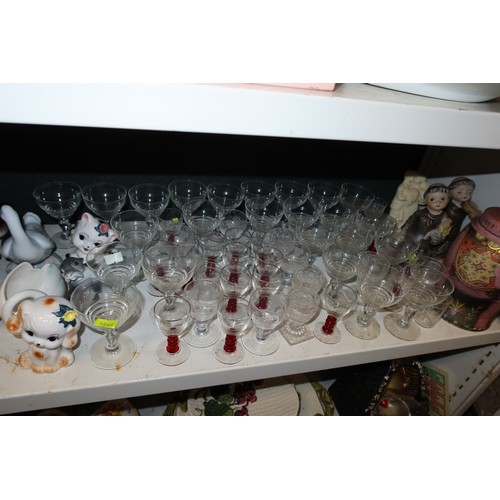 3057 - A quantity of miscellaneous decorative tea ware, glassware, ornaments and trinkets etc (three shelve... 