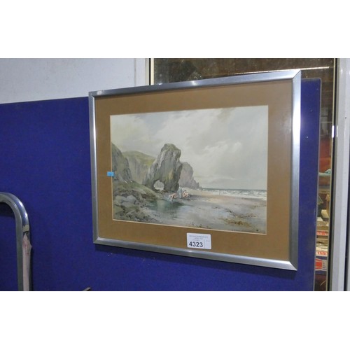A framed watercolour of a beach scene with children, signed George Goodall