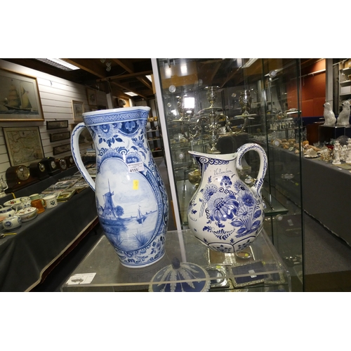 4155 - Two large blue and white pictorial and floral decorated Delft jugs