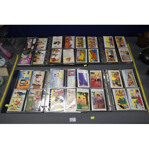 4208 - Four albums containing a large quantity of vintage saucy seaside postcards