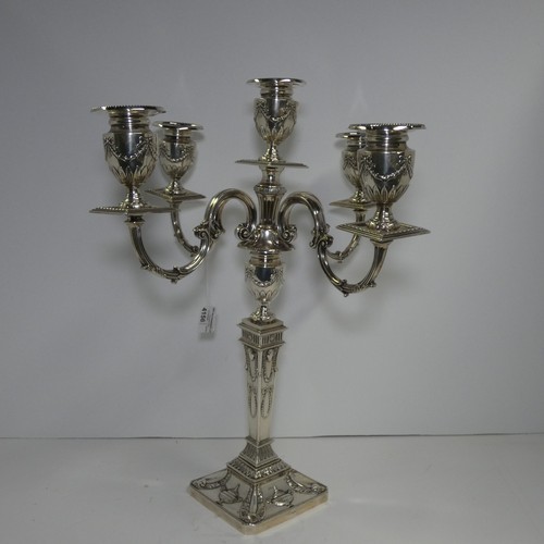 4156 - An Elizabeth 2nd very ornate embossed silver five branch candelabra with a square tapered column & s... 