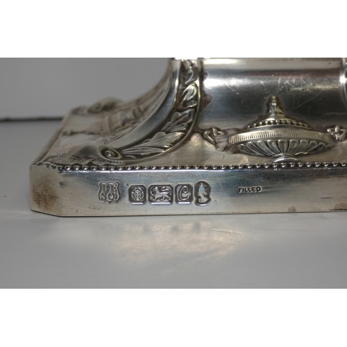 4156 - An Elizabeth 2nd very ornate embossed silver five branch candelabra with a square tapered column & s... 