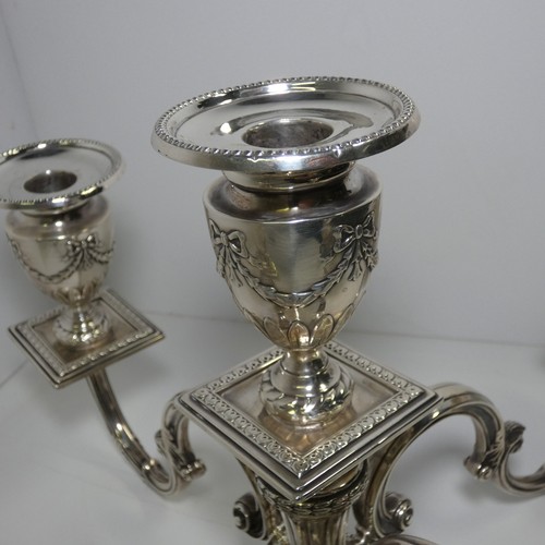 4156 - An Elizabeth 2nd very ornate embossed silver five branch candelabra with a square tapered column & s... 