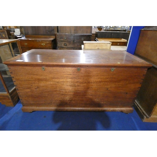 4413 - A very large hardwood storage chest with a lift lid, three heavy brass hinges and three lockings spa... 