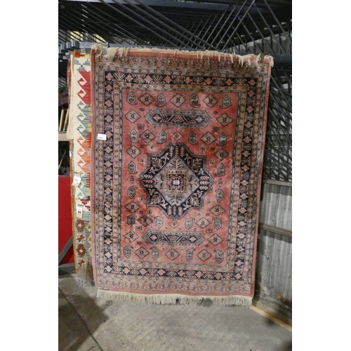 A pink pattern medallion rug, approximately 70 inches X 48 inches