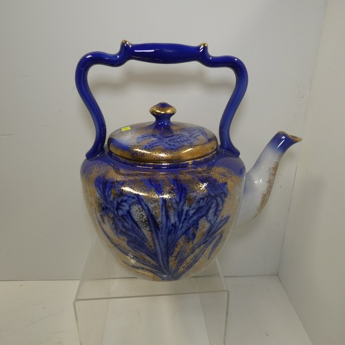 A large blue and white floral patterned ceramic kettle