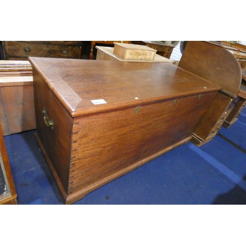 4413 - A very large hardwood storage chest with a lift lid, three heavy brass hinges and three lockings spa... 