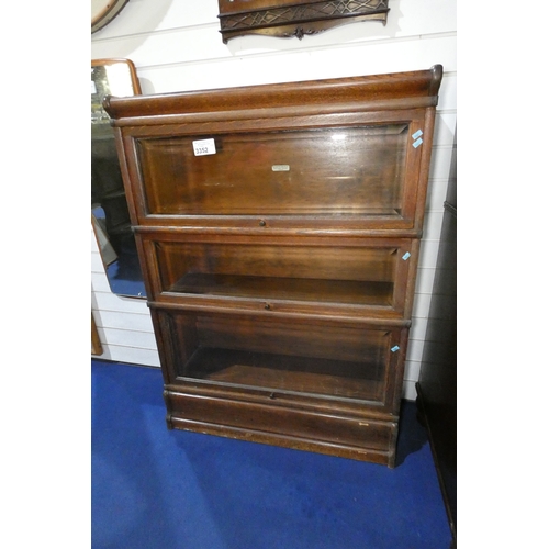 3352 - A three part vintage dark oak Globe Werniche sectional bookcase with three fall front glass doors, a... 