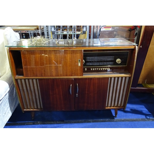 3410 - A 1960s vintage wooden cased radiogram/cocktail cabinet with sliding doors enclosing record  playing... 