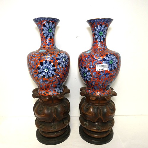 3216 - A pair of blue and red floral patterned vases by Chung with two heavy decorative wooden bases