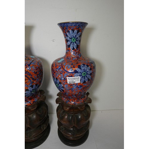 3216 - A pair of blue and red floral patterned vases by Chung with two heavy decorative wooden bases
