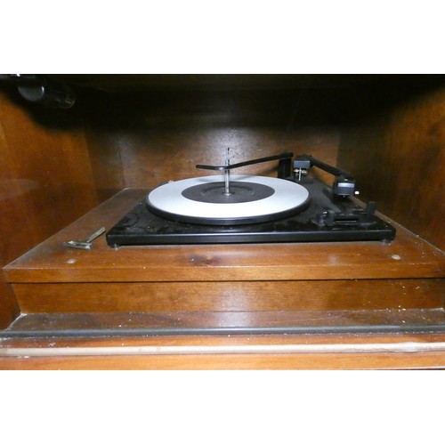 3410 - A 1960s vintage wooden cased radiogram/cocktail cabinet with sliding doors enclosing record  playing... 