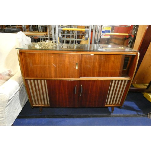 3410 - A 1960s vintage wooden cased radiogram/cocktail cabinet with sliding doors enclosing record  playing... 
